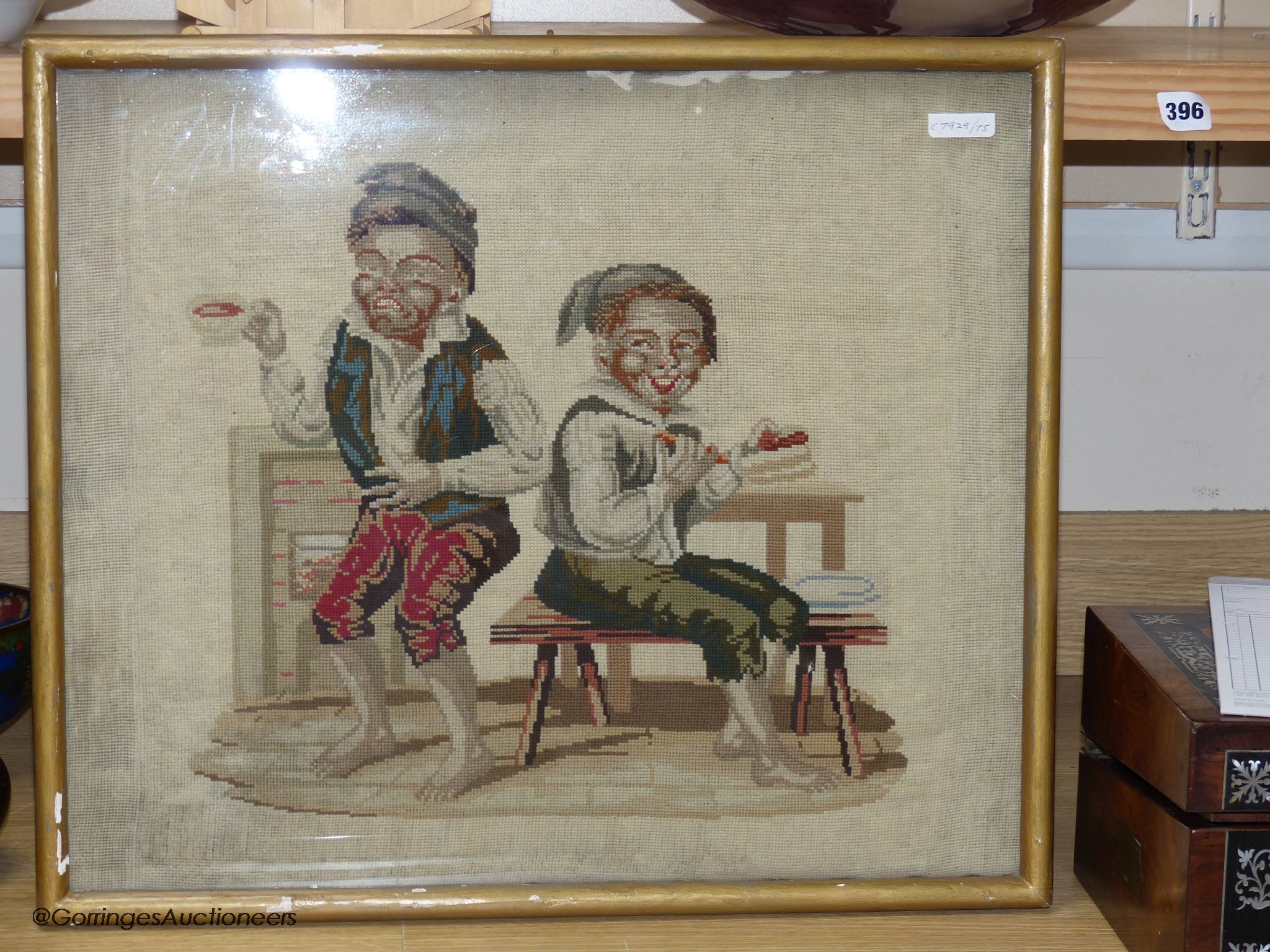 A Victoian petit-point needlework picture, two playful youths